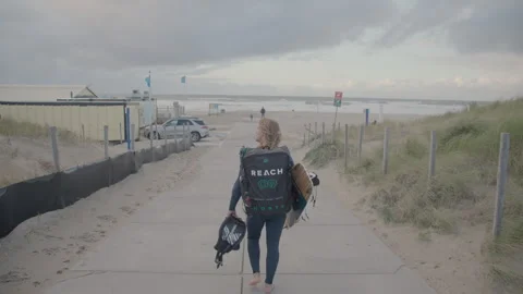 Walking to the beach before kitesurfing session Stock Footage 262757817