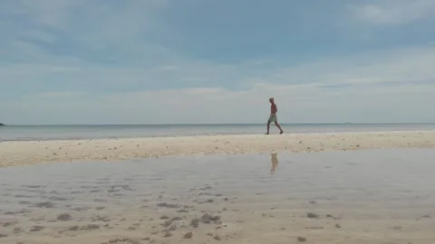 Walking on the beach - low angle drone shot 動画素材 260431195