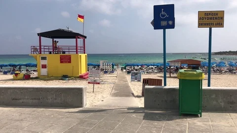 Walking on the Beach Path Next to the Lifeguard Tower. Beach Lifeguard Tower Stock Footage 101250523