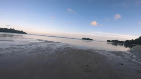 Walking on beach side during low tide sunset time with beautiful ocean water ref Stock Footage 252179272