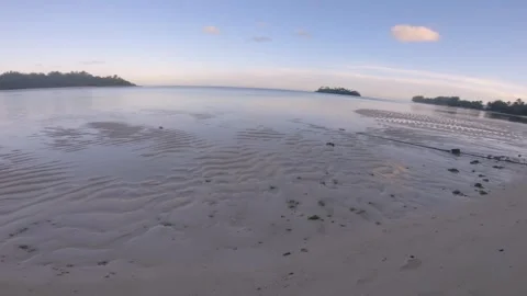Walking on beach side during low tide sunset time with beautiful ocean water ref Video stock 252179612