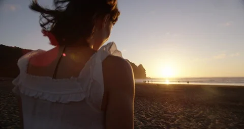 Walking on beach sun flares Stock Footage 125389902