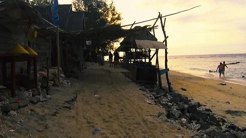Walking on the beach in sunset hour Stock Footage 78016112