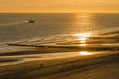 Walking on the beach at sunset. Stock Photos