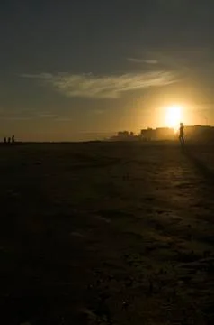 Walking on the Beach at Sunset Stock Photos