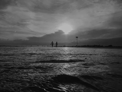 Walking on the Beach at Sunset Stock Photos