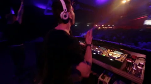 Walking behind two DJ's on a big stage. Stock Footage 54998477