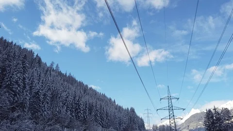 Walking below electricity pylon in winter in Alps, Austria, 4k Stock Footage 102292567