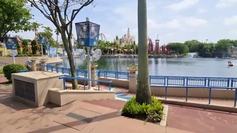 Walking beside the lake at Universal Studios Singapore Stock Footage 264940095