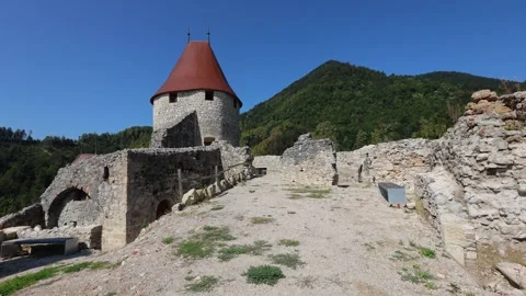 Walking Between Castle Ruins Toward Rebuilt Castle Tower at Žovnek Castle Stock Footage 282671830