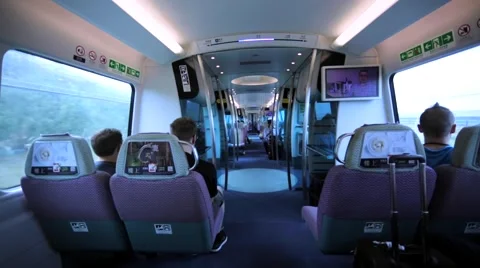 Walking between comfortable seats in Hong Kong train going fast to the airport. Stock Footage