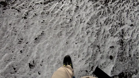 Walking on black sand coast, camera' view is changing view from boots to ocean Stock Footage 105355994