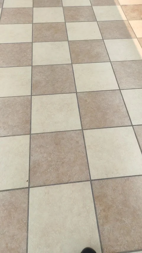 Walking on a brown ceramic tile bottom shot Vidéo 254358449