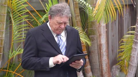 Walking Businessman With Tablet Stock Footage 36805603