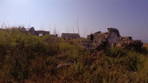 Walking closer view look out to abandoned antique historical ruin site village o Stock Footage 242327306