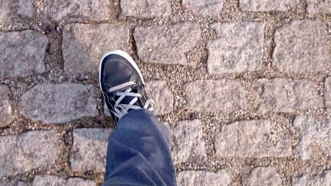 Walking on a cobblestone street Stock Footage 95764358
