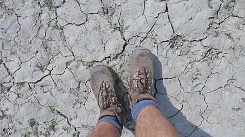 Walking on desert dry soil, first point of view. Climate change, global warming Stock Footage 68056950