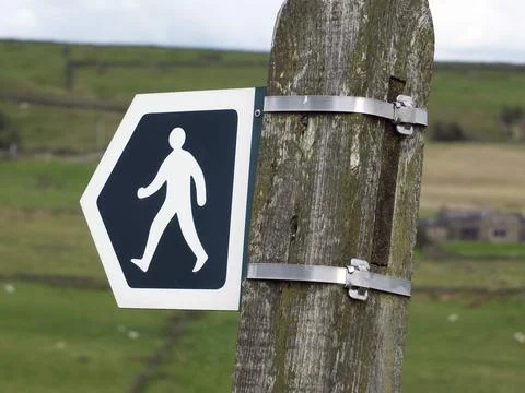 Walking direction sign indicating a path or public footpath or right of way in Stock Photos