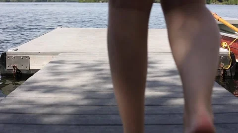 Walking to dock edge and getting foot wet Stock Footage 64983468