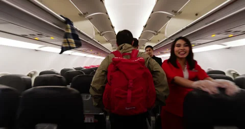 Walking down the aisle of airliner after landing, first person view shot Stock Footage 329460612
