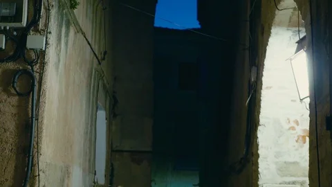 Walking down and panning up in a old textural street in southern europe Stock Footage 88903461