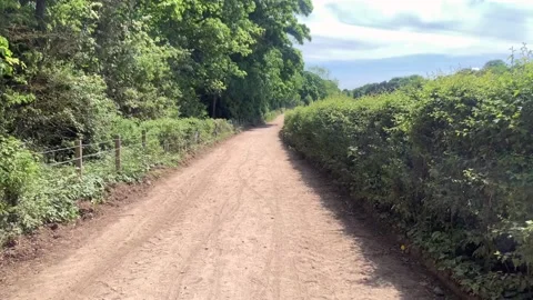 Walking down a bridal path in the countryside on a summer's day in Yorkshire Stock Footage 130831488