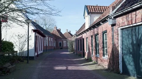 Walking down a charming historic street in a dutch village Видео 331188895