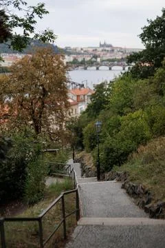 Walking down a cobblestone path in a lush green park overlooking prague vys.. Stock Photos