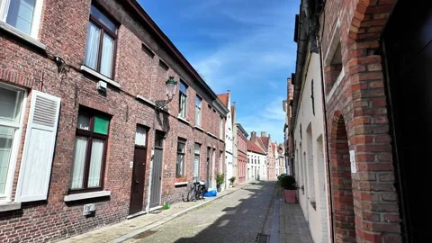 Walking down a cobblestone street lined with magnificent Gothic facades in Bruge Vídeos de archivo 333202735