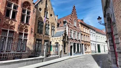 Walking down a cobblestone street lined with magnificent Gothic facades in Bruge Vídeos de archivo 333202763