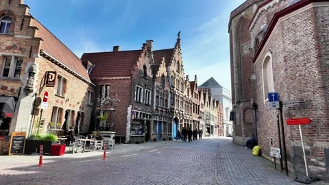 Walking down a cobblestone street lined with magnificent Gothic facades in Bruge Vídeos de archivo 333202768
