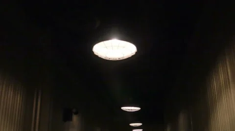 Walking Down Dark Hallway with Bright Lights on Ceiling, 4K Stock-Footage 61526600