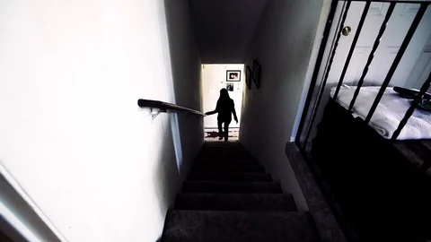 WALKING DOWN DARK STAIRS Stock Footage 81632118
