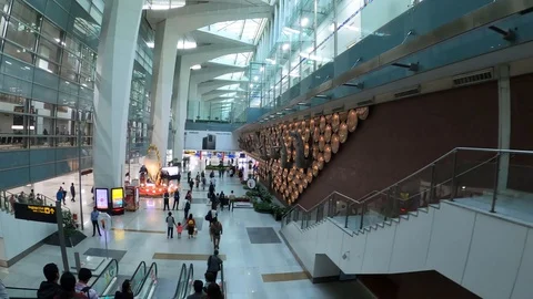 Walking down the escalator after arriving at T3 Terminal, Delhi Airport, India Stock Footage