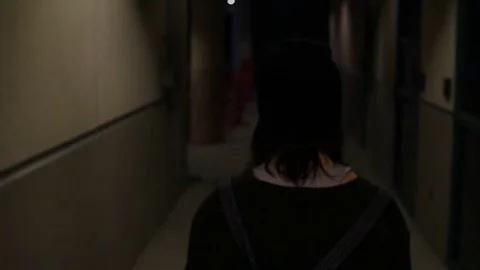 Walking down a hallway alone at night Stock Footage 79336970