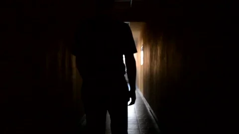 Walking down a hallway towards the light and back Stock Footage