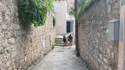 Walking down a historic stone staircase in Dubrovnik Stock Footage 344391846