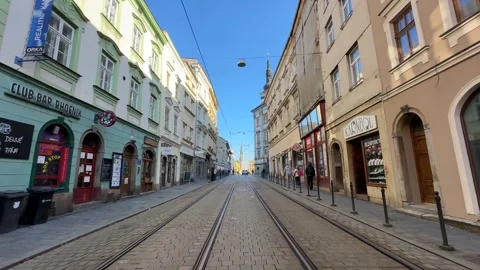 Walking down historic streets with many people in Olomouc, tram view Stock Footage 263483953