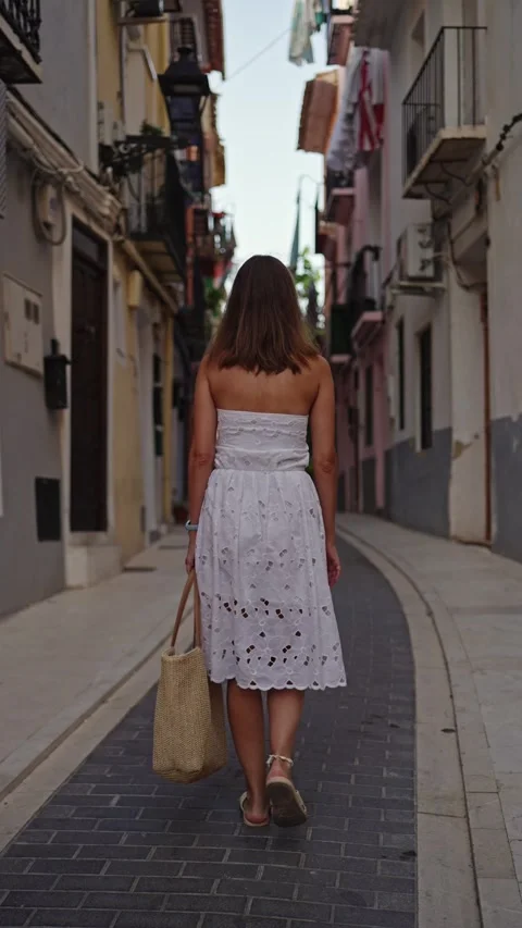 Walking down a narrow street in a coastal town during the afternoon Stock Footage 346016775