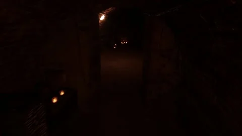 Walking down old cellars. Walk along an old underground corridor lit by candle Video stock 311119373