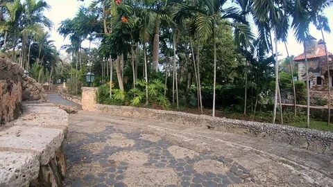 Walking down pathway in Altos de Chavon La Romana Casa De Campo in Punta Cana Stock Footage 88112284
