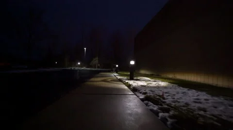 Walking down poorly-lit sidewalk in the dark Stock Footage 59562337