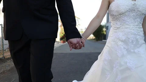 Walking Down the Road Holding Hands Stock Footage 114889798