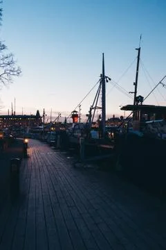 Walking down a small pier at sunset with lots of small boats, Stockholm Swede Stock Photos