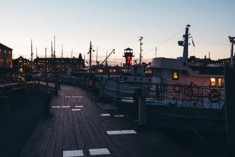 Walking down a small pier at sunset with lots of small boats, Stockholm Swede Stock Photos