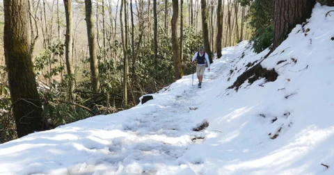 Walking down snow covered trail Stock Footage 53859946