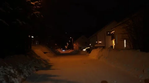 Walking down snowy residential road at night in Tromso, Norway Stock Footage 301466476