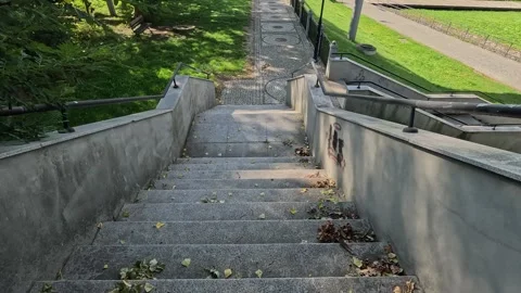 Walking down the stairs and along the riverside promenade. Stock Footage 318825805