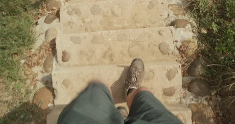 Walking down stairs in arid  desert landscape with professional hiking shoes Stock Footage 86101435