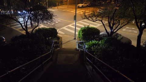 Walking Down Stairs at Night to Intersection Stock Footage 101445119